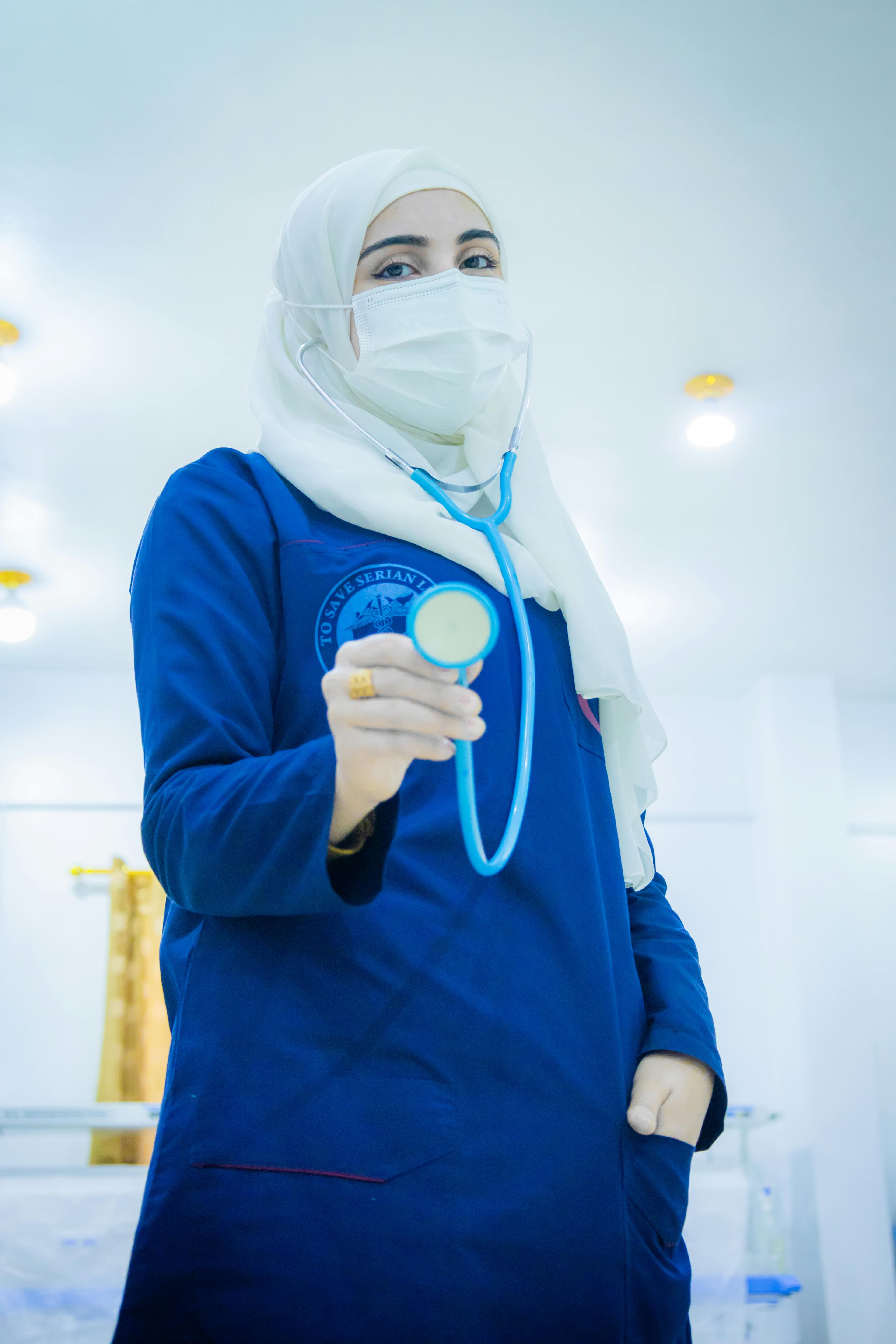 Doctor holding a stethoscope in a clinical setting