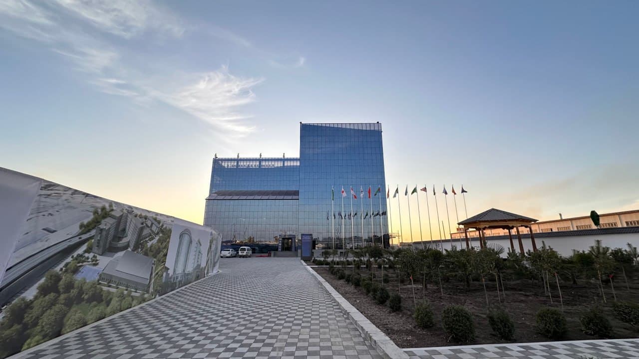 The modern Ma'mun University campus building and landscaped grounds in Khiva, Uzbekistan.