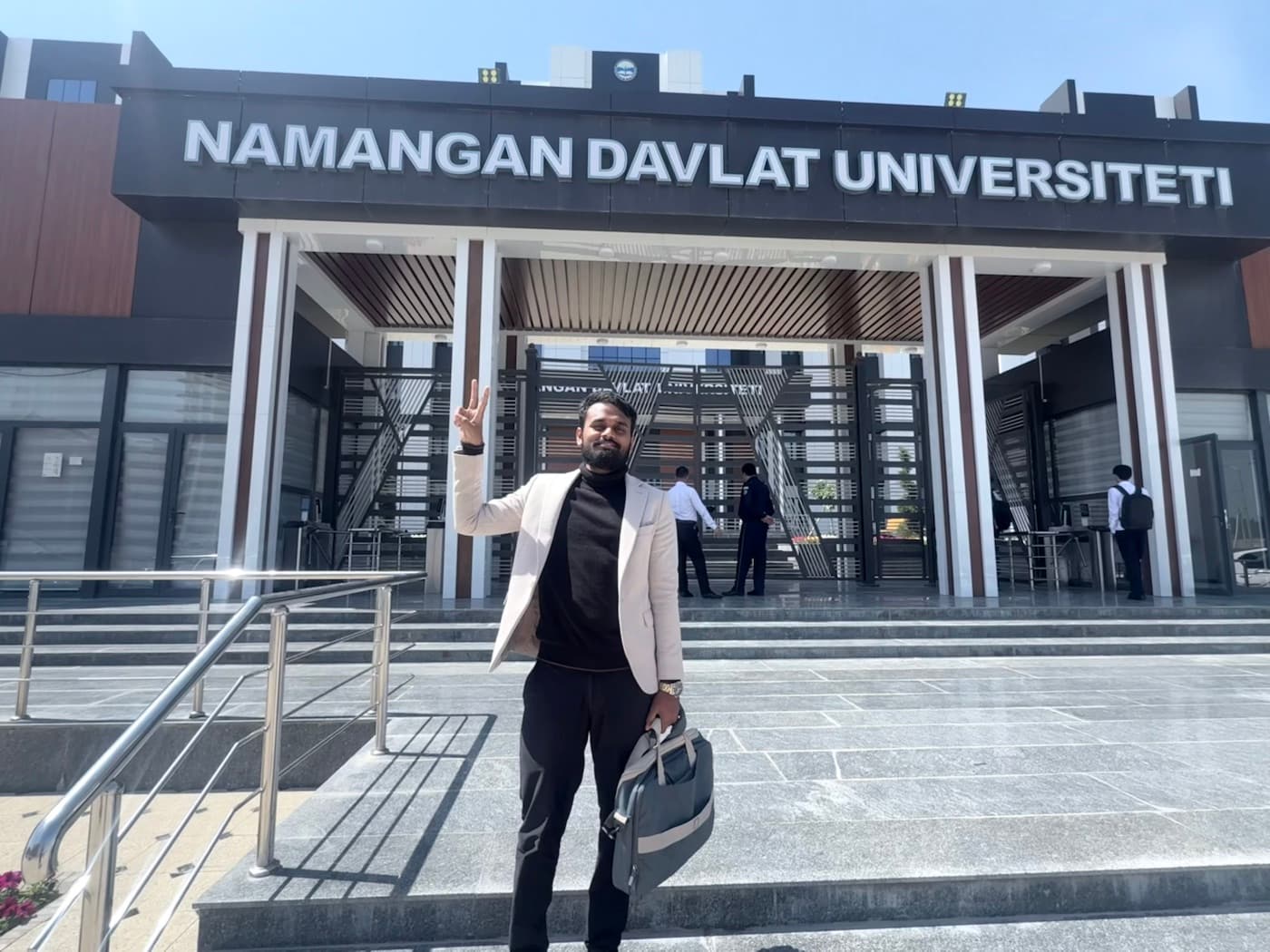 Dr. Ravi standing in front of Namangan State University Faculty of Medicine during his campus visit in Namangan, Uzbekistan.